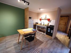 a kitchen with a wooden table and a kitchen with a counter at Casa Lorvic 2 in Malargüe