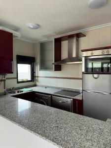 a kitchen with stainless steel appliances and granite counter tops at Mirador de Usil in Mogro