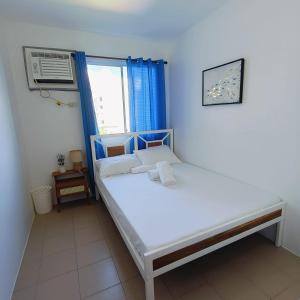 a small bedroom with a bed and a window at Makai Home at Marian Spatial Dumaguete in Dumaguete +35 photos