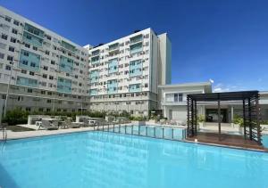 a large swimming pool in front of a building at Makai Home at Marian Spatial Dumaguete in Dumaguete