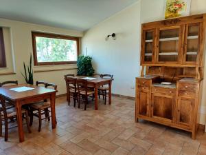 a dining room with wooden tables and chairs and a window at Angelucci Agriturismo con Camere e Agri Camping in Lanciano