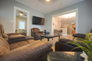 a living room with couches and a table and a living room at Large 6BR, 2 bath in Niagara Falls in Niagara Falls