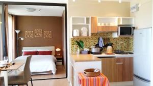 a kitchen and a bedroom with a bed and a desk at Cozy Lake and Mountain View Apartment in Bang Tao Beach