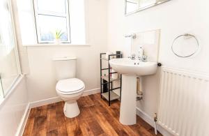 a bathroom with a toilet and a sink at Beach House in Thurso +28 photos