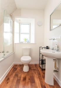 a bathroom with a toilet and a sink at Beach House in Thurso