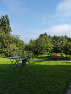 a picnic table and a bench in the grass at Solapetxea Loft rural in Elosu +4 photos