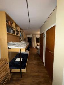 a hallway with two beds in a room at Sestriere Gem Comfy Apartment with Ski Views in Sestriere