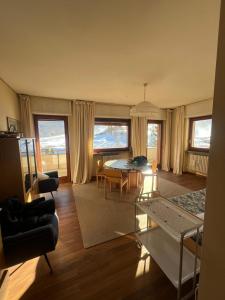 a living room with a table and a dining room at Sestriere Gem Comfy Apartment with Ski Views in Sestriere