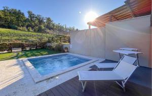 a patio with a pool and a chair and a table at 3 Bedroom Beautiful Home In Montebuono in San Savino +27 photos