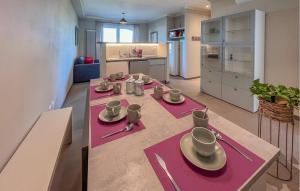 a kitchen with a table with plates and cups on it at Amazing Home In Montebuono in Montemelino