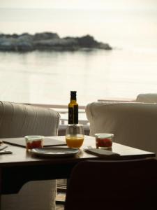 a bottle of wine sitting on a table with a glass at Hostal Empúries in L'Escala