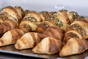 a tray filled with lots of different types of bread at B&B Kovač in Portorož +12 photos