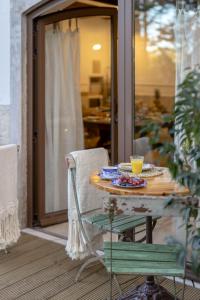 a table with a plate of food on a porch at Casa da Estefânea in Sintra