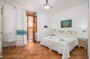 Postel nebo postele na pokoji v ubytování Bosa Queen House