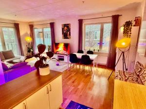 a living room with a couch and a table and chairs at Comfortable room in Oslo