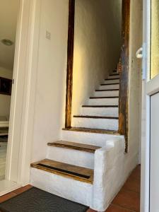 a staircase in a house with a mirror on the wall at Studio Oaza Čačak in Čačak