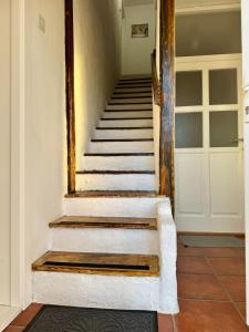 a staircase in a house with a mirror on the wall at Studio Oaza Čačak in Čačak +4 photos