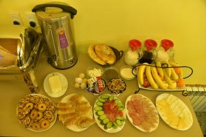 a counter topped with lots of different types of food at Mulberry Hotel in Tashkent