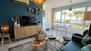 a living room with a couch and a tv and a table at Primera línea playa Apart 1 Bed CostaOro-CO1BA DELUXE Seafront ó Loft-Studio CostaOro-CO1BB STANDARD in Torrox Costa
