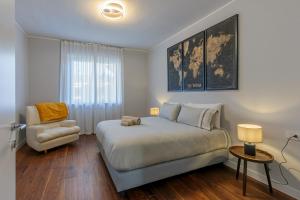 a bedroom with a large bed and a chair at Villa Ceratti in Cassano Magnago +37 photos