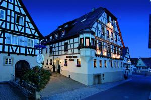 a large building with people standing outside of it at Hotel Lamm in Weinstadt