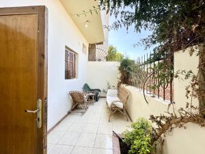 an open door to a patio with chairs and a table at Sunset Haven Guesthouse in Luxor