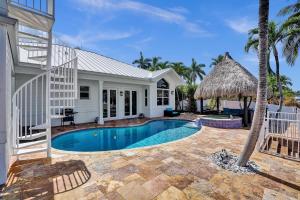 a swimming pool in the backyard of a house at Villa Horizon - Stunning waterfront villa in Boca Raton in Boca Raton