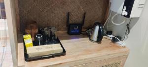 a counter with a coffee maker and other items on it at Cinta Hiriketiya in Dickwella