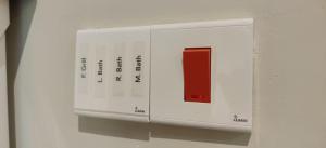 a white lightswitch on a wall with a red button at Cinta Hiriketiya in Dickwella +13 photos