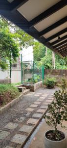 a patio with a potted plant and a fence at Cinta Hiriketiya in Dickwella