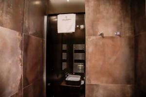 a bathroom with a toilet with a sign on the wall at Trèscharme in Andria +66 photos