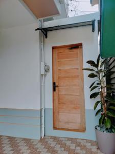 a door in a house with a plant at Family Suite 4-6 Pax GLENMARK'S Homestay near the beach in Pagudpud +10 photos