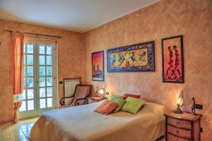 a bedroom with a bed and a chair at VILLA IPAZIA 6, Emma Villas in Sonnino +21 photos