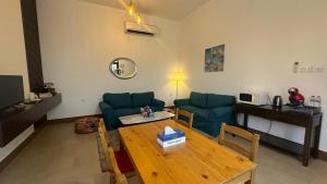 a living room with a table and a blue couch at 2 Bedroom Villa in Ras Al Khaimah with Privat swimming Pool in Ras al Khaimah