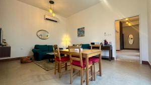 a living room with a table and a green couch at 2 Bedroom Villa in Ras Al Khaimah with Privat swimming Pool in Ras al Khaimah