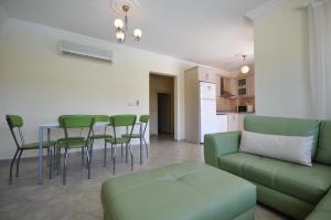 a living room with a couch and a table and chairs at Villa Romantica 17 in Milas