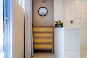 a bathroom with a staircase and a mirror at Cozy Cottage in Constantia in Cape Town
