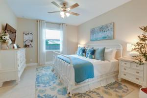 a bedroom with a white bed and a window at Stylish Port St Lucie Home with Hot Tub and Game Room! in Walton