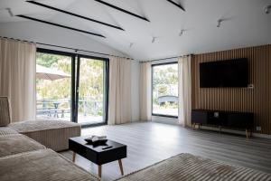 a living room with a couch and a flat screen tv at Dom na wsi, Agroturystyka BlueBeaver in Wleń