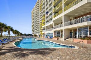 a swimming pool in front of a building at Baywatch Resort Oceanfront Dream Maker in Myrtle Beach