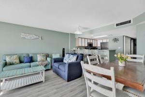 a living room and kitchen with a couch and a table at Baywatch Resort Oceanfront Dream Maker in Myrtle Beach