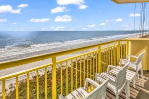 a balcony with chairs and a view of the beach at Baywatch Resort Oceanfront Dream Maker in Myrtle Beach