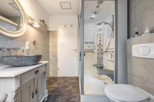 a bathroom with a sink and a shower at Ferienwohnung Solling-Lounge in Holzminden +21 photos