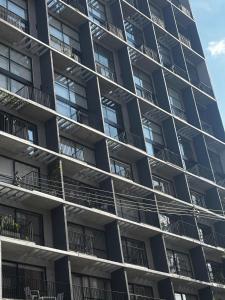 a tall apartment building with balconies on it at Encantador Loft urbano en el corazón de Medellín in Medellín