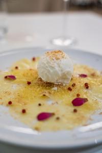 a plate of food with a scoop of ice cream on top at Palmares Beach House Hotel - Adults Only in Lagos