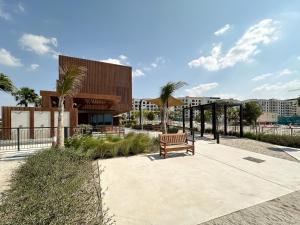 a bench sitting on a sidewalk in front of a building at Trophy - Beach Daze Condo in Lamer W Sea Views in Dubai