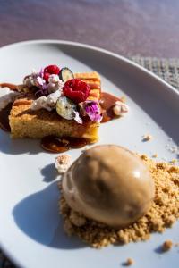 a white plate with a piece of cake and a donut at Palmares Signature Apartments in Lagos