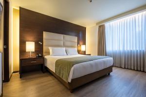 Postel nebo postele na pokoji v ubytování Hotel Estelar Milla De Oro