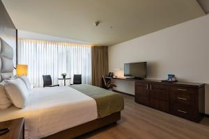 Postel nebo postele na pokoji v ubytování Hotel Estelar Milla De Oro