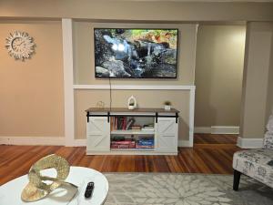 a living room with a flat screen tv on the wall at Providence Place Apartment in Providence +8 photos